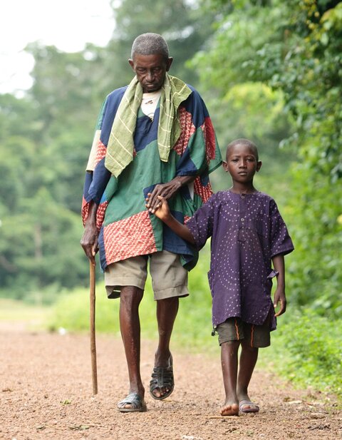 Boy leading man blinded by oncho