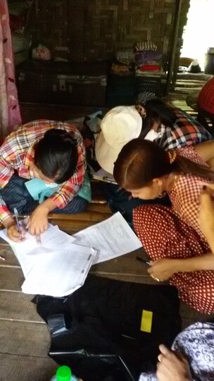 Community volunteers record questionnaire answers - Yangon region, Myanmar