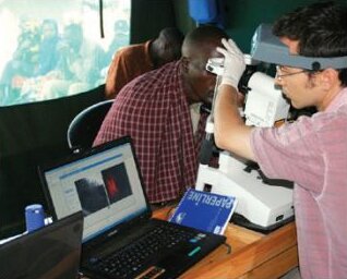 A researcher performs In Vivo Confocal Microscopy on the conjunctiva of a man with trachoma. Credit: Matthew Burton.