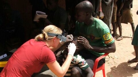 Dr Anna Last examining a patient for trachoma. Image courtesy of LSHTM